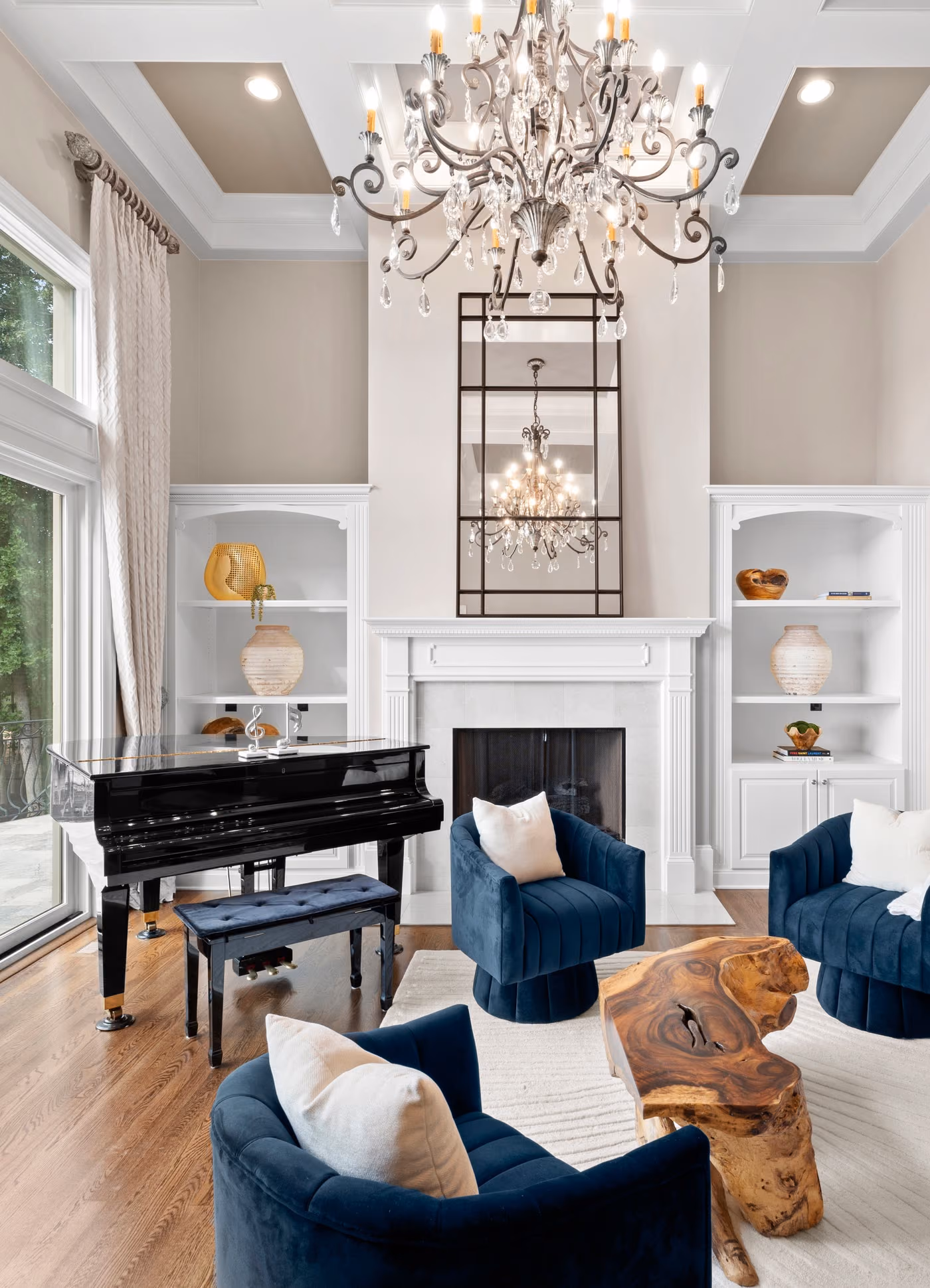 A tall living room with a grand piano and glass doors onto the terrace.